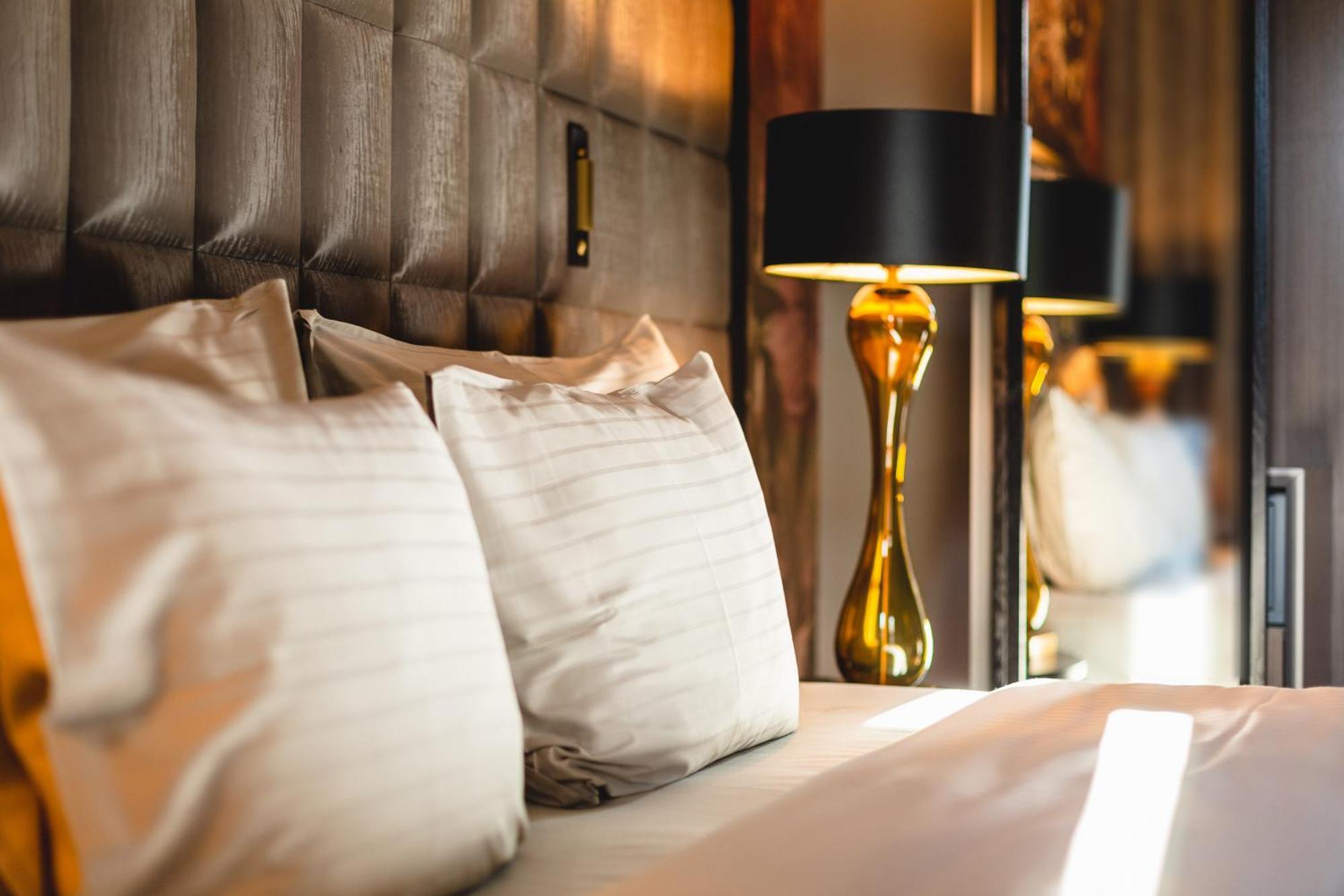 Grand Poet Hotel And Spa By Semarah Riga Bagian luar foto A bed with pillows